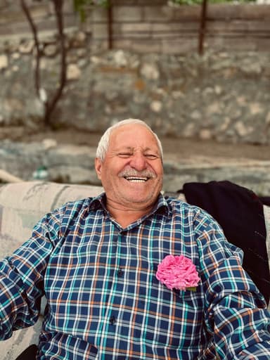 A father laughing, a rose in his shirt pocket