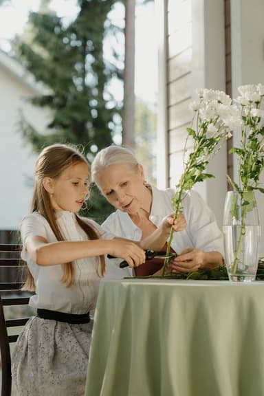 Grandmother and granddaughter arranging flowers